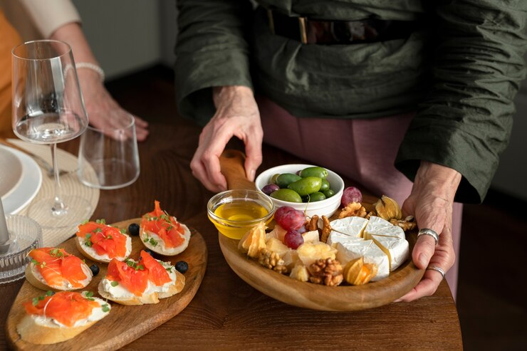 Hands Holding Tasty Food Board